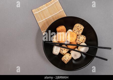 Many different delicious mochi on grey table, flat lay. Traditional Japanese dessert Stock Photo