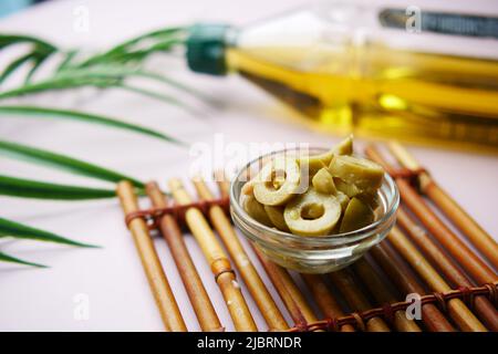 a jar of olive in a glass jar on table  Stock Photo