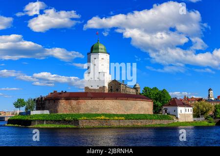 Medieval fortress in Vyborg. Castle on the water against the blue sky Stock Photo