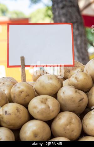 pile of potatoes with and empty label on Stock Photo