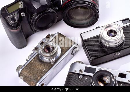 Close-up old-fashioned vintage photo cameras on white background. Collection of photography devices. Stock Photo