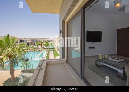 Terrace balcony of a luxury apartment in tropical resort with swimming pool view and garden Stock Photo