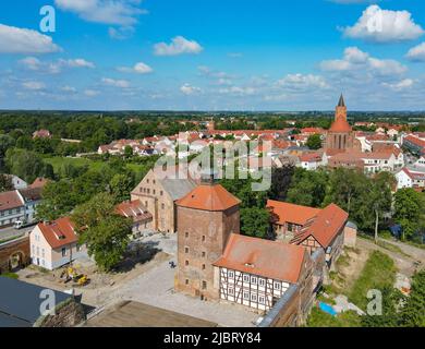 Beeskow, Germany. 02nd June, 2022. Beeskow Castle, first mentioned in a document in 1316 (aerial photograph taken by drone). 30 years of culture in the Oder-Spree district are now being celebrated in a big way at Beeskow Castle. The medieval complex combines an ensemble of now renovated buildings with different cultural uses: modern regional museum, historical music automatons, concert hall, open-air stage, artists' workshops. (to dpa 'How a medieval castle complex became a cultural center') Credit: Patrick Pleul/dpa/Alamy Live News Stock Photo