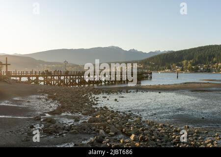 Rocky Point Park during sunset time. Long pier over the ocean. Port Moody, British Columbia, Canada. Stock Photo