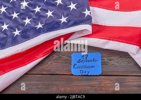 17 september constitution of the USA concept. Large flag with stripes and stars. Wooden desk background. Stock Photo