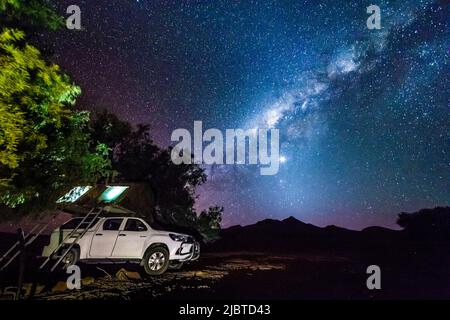 Namibia, Kunene region, Damaraland, Bergsig, 4x4 camp and tent under the Milky Way Stock Photo