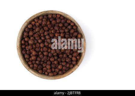 pile of brown chickpeas in wooden bowl isolated on white background, top view Stock Photo