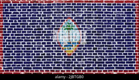 Close-up on a brick wall with the flag of Guam painted on it. Stock Photo
