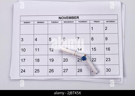 No smoking day in 21 of november. White month calendar. Broken cigarette on the push pin. Stock Photo