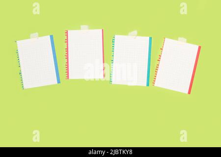 Colored frame squared sheets of paper with copy space on a green background Stock Photo
