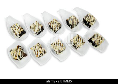 Toffy Cake topping with almond and cashew nut in white ceramic cup on white isolated. Stock Photo