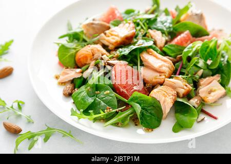 Grilled salmon salad with grapefruit, almonds and salad mix Stock Photo