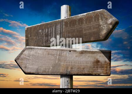 Wooden crossroad sign with two arrows Stock Photo