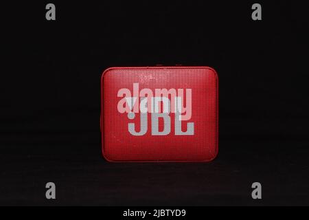 JBL portable speaker in red isolated on black Stock Photo