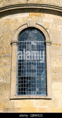 Large arched leaded light church window in circular wall Stock Photo