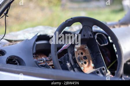 Close-up of the steering wheel of a car after the accident. No driver airbag. The steering wheel of a car after being shot from an airbag close-up. Br Stock Photo