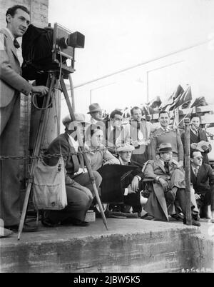 Still Photographer MACK ELLIOTT Cinematographer BARNEY McGILL RICHARD BARTHELMESS and Director MICHAEL CURTIZ on set candid with Movie Crew during filming of ALIAS THE DOCTOR 1932 director MICHAEL CURTIZ First National Pictures / Warner Bros. Stock Photo