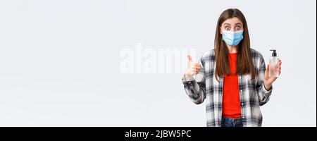 Coronavirus outbreak, leisure on quarantine, social distancing and emotions concept. Amazed and impressed girl in medical mask, want prevent catching Stock Photo