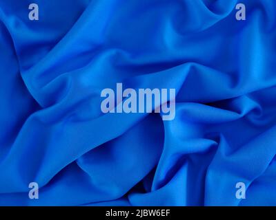 A blue wrinkled fabric texture background. Close up. Stock Photo