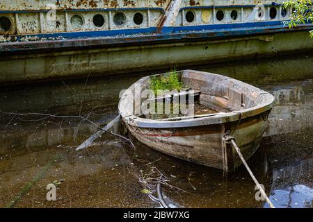 old rotten sunken boat tied to the shore. High quality photo Stock Photo