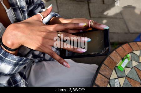 Woman's hands holding mobile smartphone Stock Photo