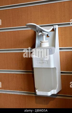 Hand sanitizer dispenser mounted on wall Stock Photo