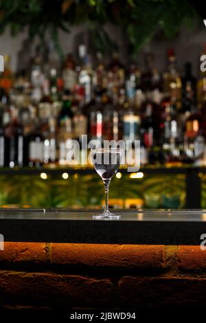Aviation, drink with gin, lemon juice, maraschino liqueur and violet cream liqueur standing on bar counter Stock Photo