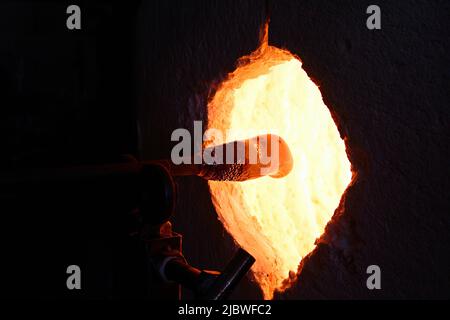 heating glass for blowing in a kiln Stock Photo