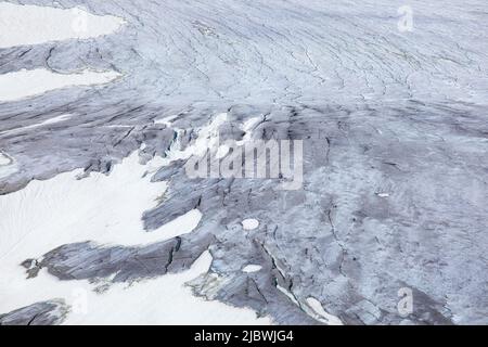 Close-up of glacier surface with visible cracks. Organic background texture. Stock Photo