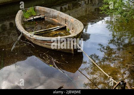 old rotten sunken boat tied to the shore. High quality photo Stock Photo