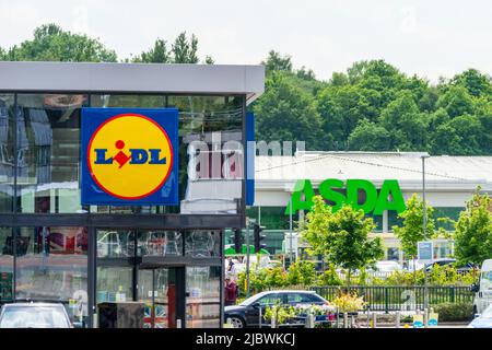 LIDL storefront, shopfront or facade with ASDA sign behind it in background. Budget supermarket, competition, rising cost of living, 'big three'. UK Stock Photo