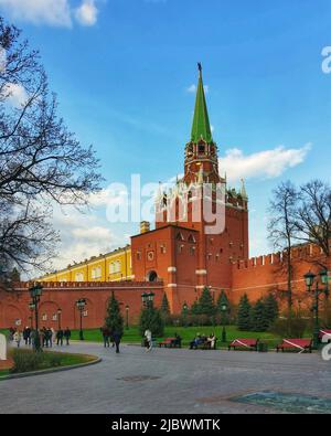 Tower of the Moscow Kremlin, Russia, April 2022. Entrance to the Red Square. People walking near the protective walls on Red Square in Moscow Stock Photo