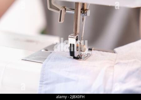 A man sews clothes on a sewing machine. Hobbies, needlework, creativity. Stock Photo