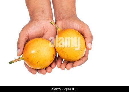 Passiflora Ligularis - Granadilla Or Chinese Pomegranate Tasty And Healthy Fruit; In Male Hand On White Background Stock Photo