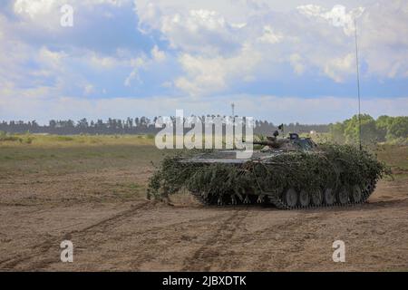 A Polish army BMP-1 infantry fighting vehicle advances onto the field at the start of a training exercise as part of Defender Europe at Mielno Range, Poland, May 27, 2022. Defender Europe 22 is a series of U.S. Army Europe and Africa multinational training exercises in Eastern Europe. The exercise demonstrates U.S. Army Europe and Africa’s ability to conduct large-scale ground combat operations across multiple theaters supporting NATO. (U.S. Army National Guard photo by Sgt. Tara Fajardo Arteaga) Stock Photo