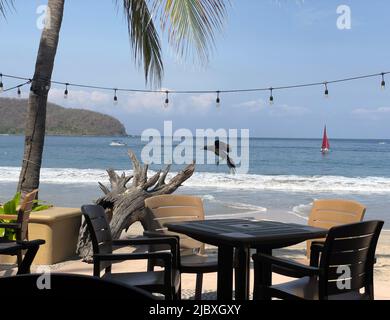 Dining at outdoor restaurant at the beach at La Playa Ropa in Zihuatanejo, Mexico Stock Photo