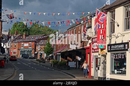 Lymm Village centre, with bunting, union British flags, for royal celebrations, Warrington, Cheshire, England, UK, WA13 0HP Stock Photo