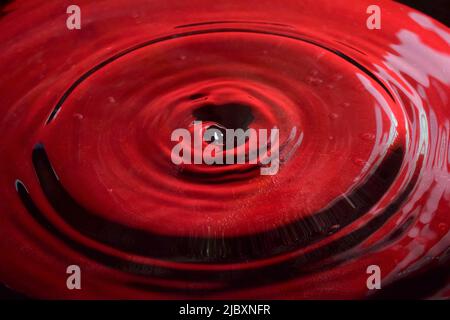 Water Drop Photography, close up with red background Stock Photo