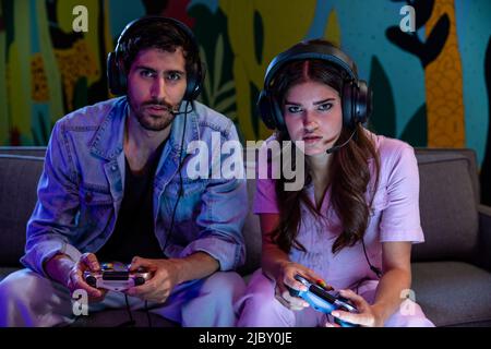 Young millennial couple playing video game at home Stock Photo