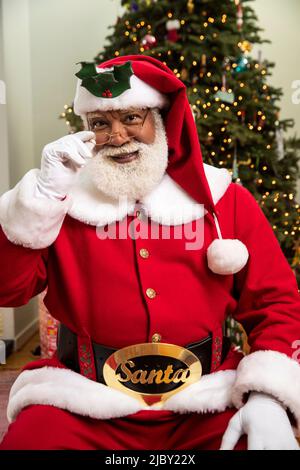 Portrait of Black Santa Claus looking into camera with happy smile. Stock Photo