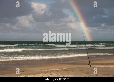 Fishing rod and buckets on beach Stock Photo - Alamy