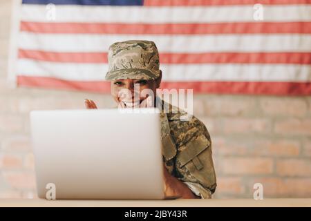 Young female soldier working with laptop in headquarters building Stock ...