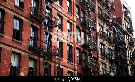 A patch of sunshine hitting an old red brick apartment building in SoHo, New York City. Stock Photo