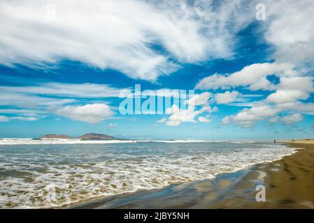 Distant people walk on Sand Dollar Beach on Pacific side of Isla Magdalena Stock Photo