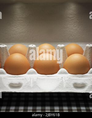 Close up of brown eggs in a grey egg carton Stock Photo