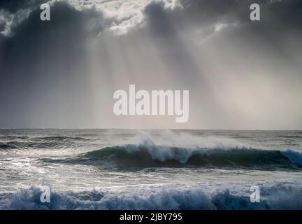 Huge wave curling over and breaking during cyclone Ola with stormy sky Stock Photo