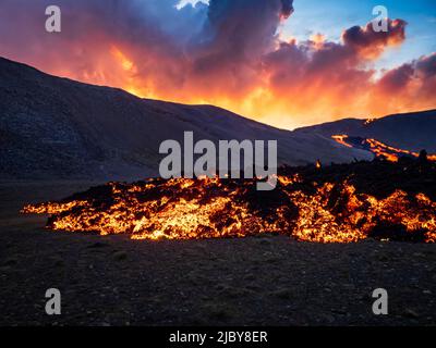 Glowing river of lava at sunset, Fagradalsfjall volcanic eruption at Geldingadalir, Iceland Stock Photo