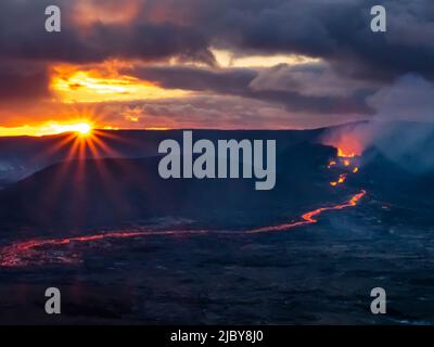 Clouds and glowing river of lava, Fagradalsfjall Volcanic eruption at sunset, Iceland Stock Photo