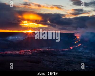 Clouds and glowing river of lava, Fagradalsfjall Volcanic eruption at sunset, Iceland Stock Photo