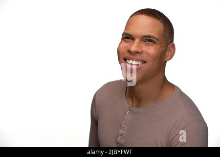 Portrait of young black man looking slightly off camera smiling Stock Photo